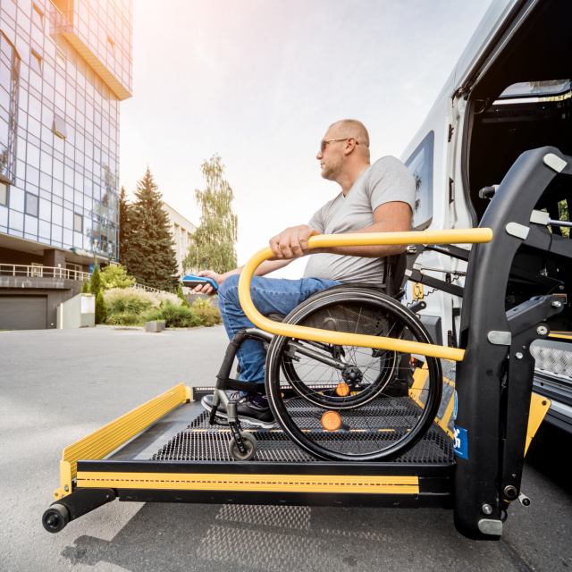 Man in wheelchair on car lift
